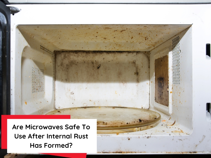 A dirty, rusty microwave oven with food splatters and a worn-out turntable.